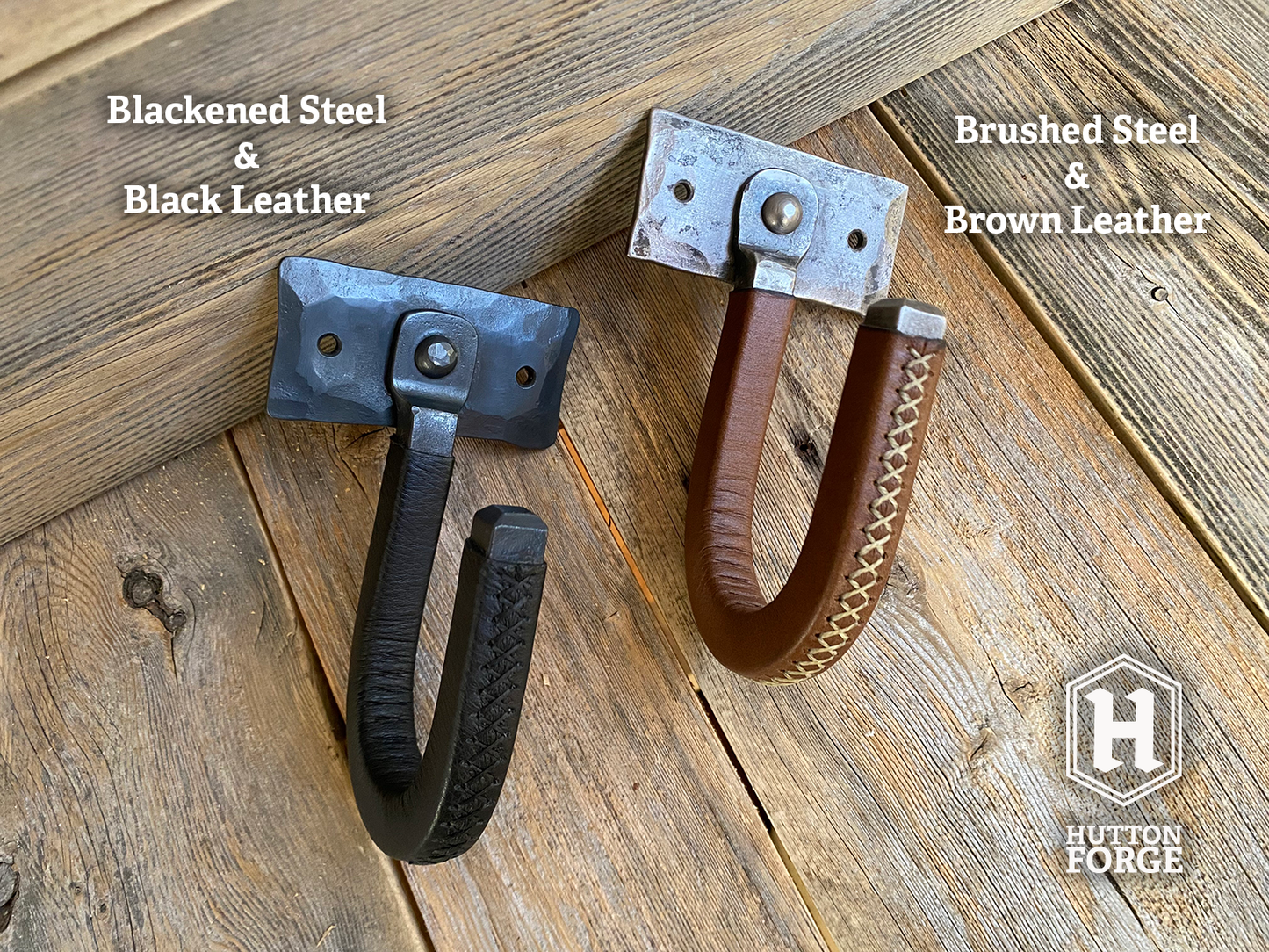 Two metal and leather wrapped wall gun hooks. One features blackened steel and black leather, the other brushed steel and brown leather. Hutton Forge