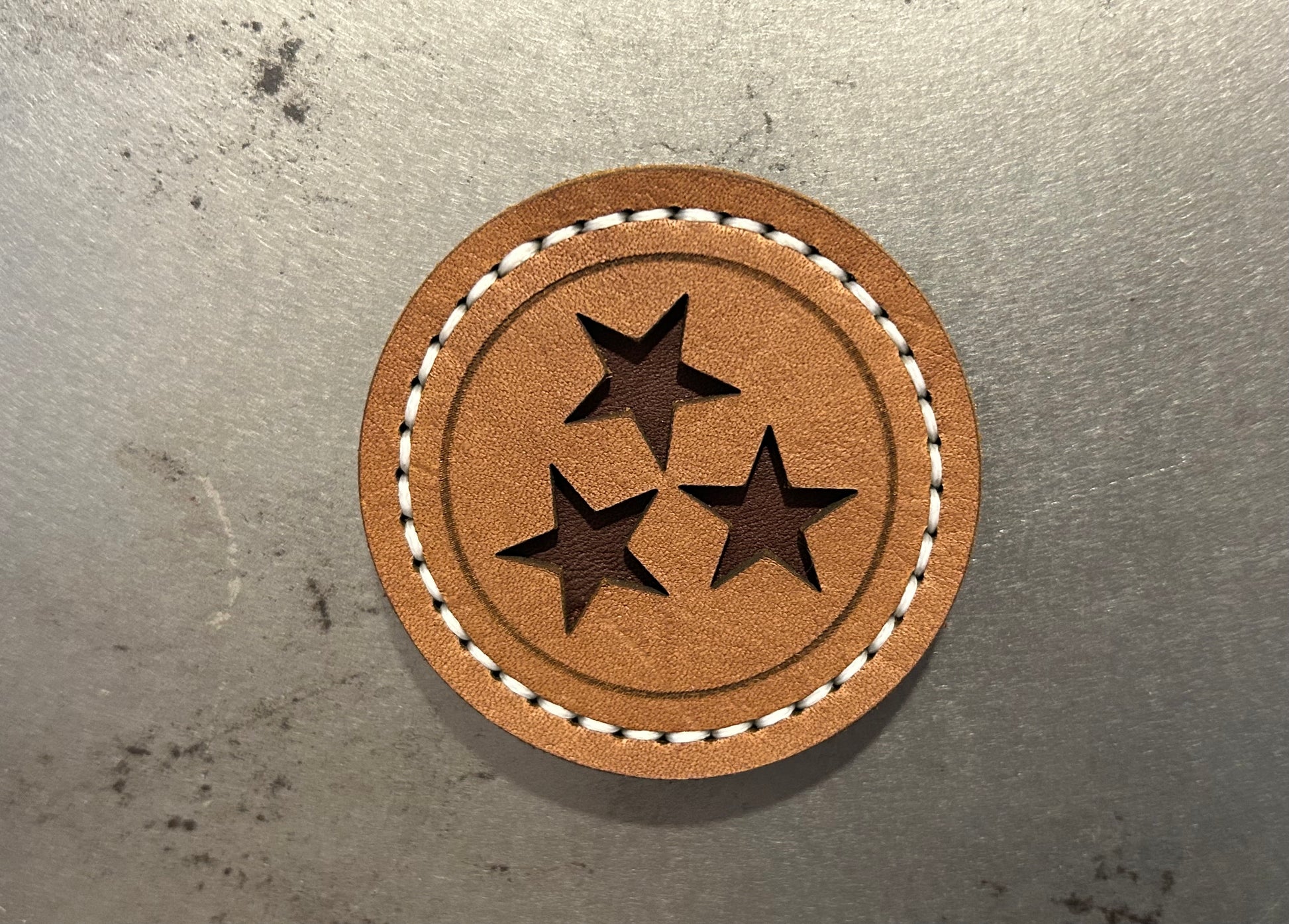 Light brown leather Tennessee magnet with brown stars and white stitching. Hutton Forge.