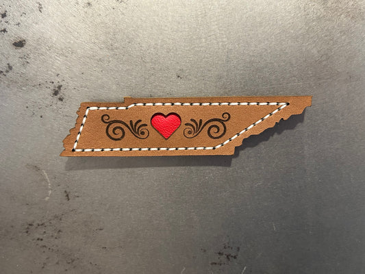 A Tennessee-shaped leather magnet with a red heart made by Hutton Forge. 