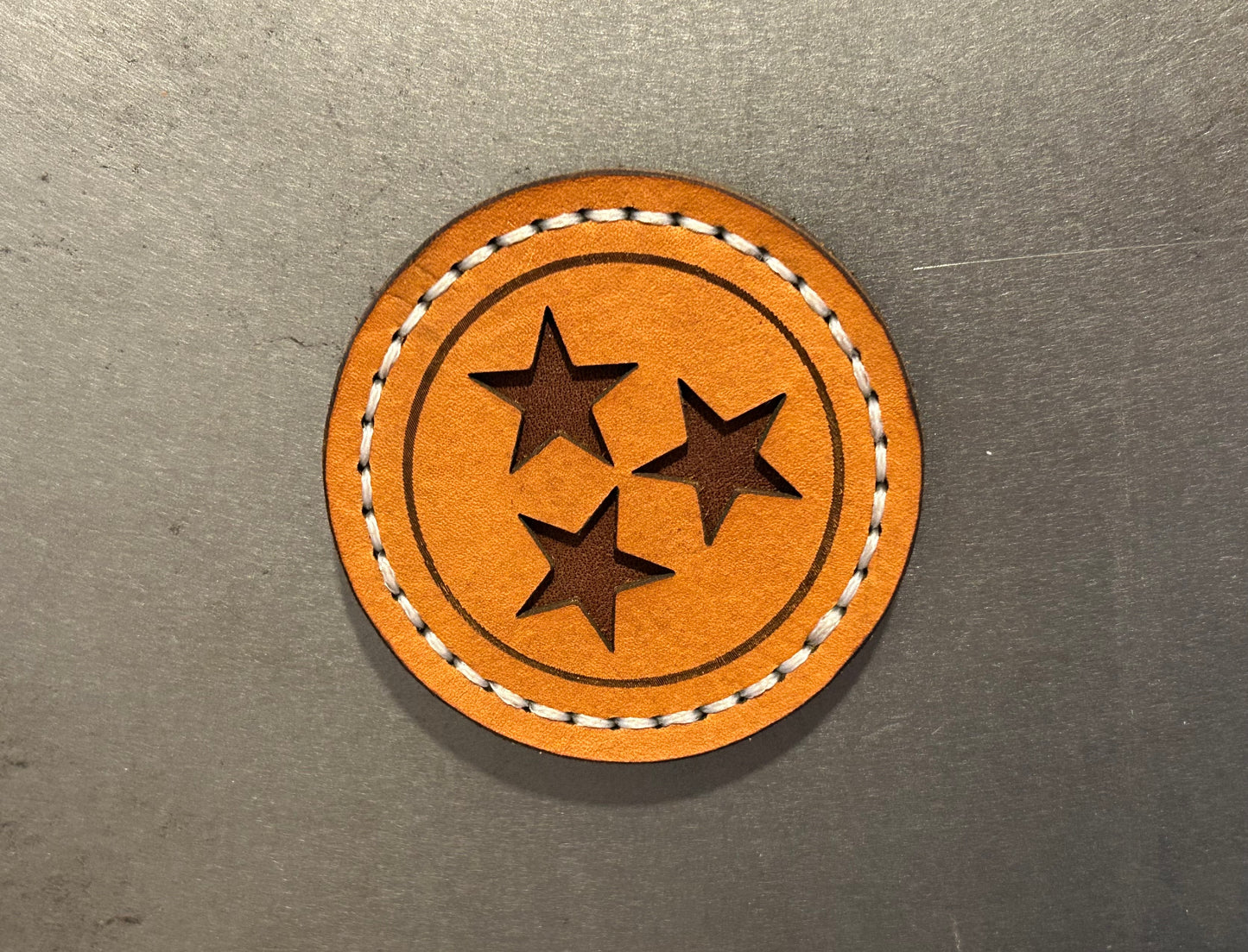 Orange leather Tennessee magnet with brown stars and white stitching. Hutton Forge.