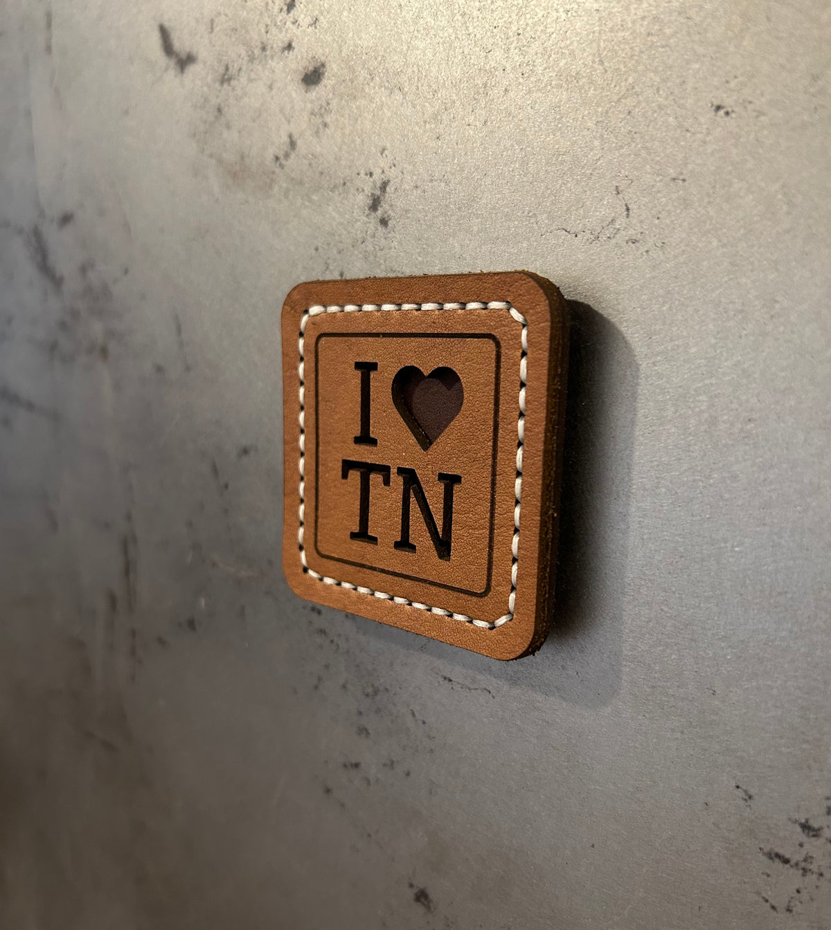 Hand-stitched brown leather magnet with an “I Love TN” design, handmade by Hutton Forge.