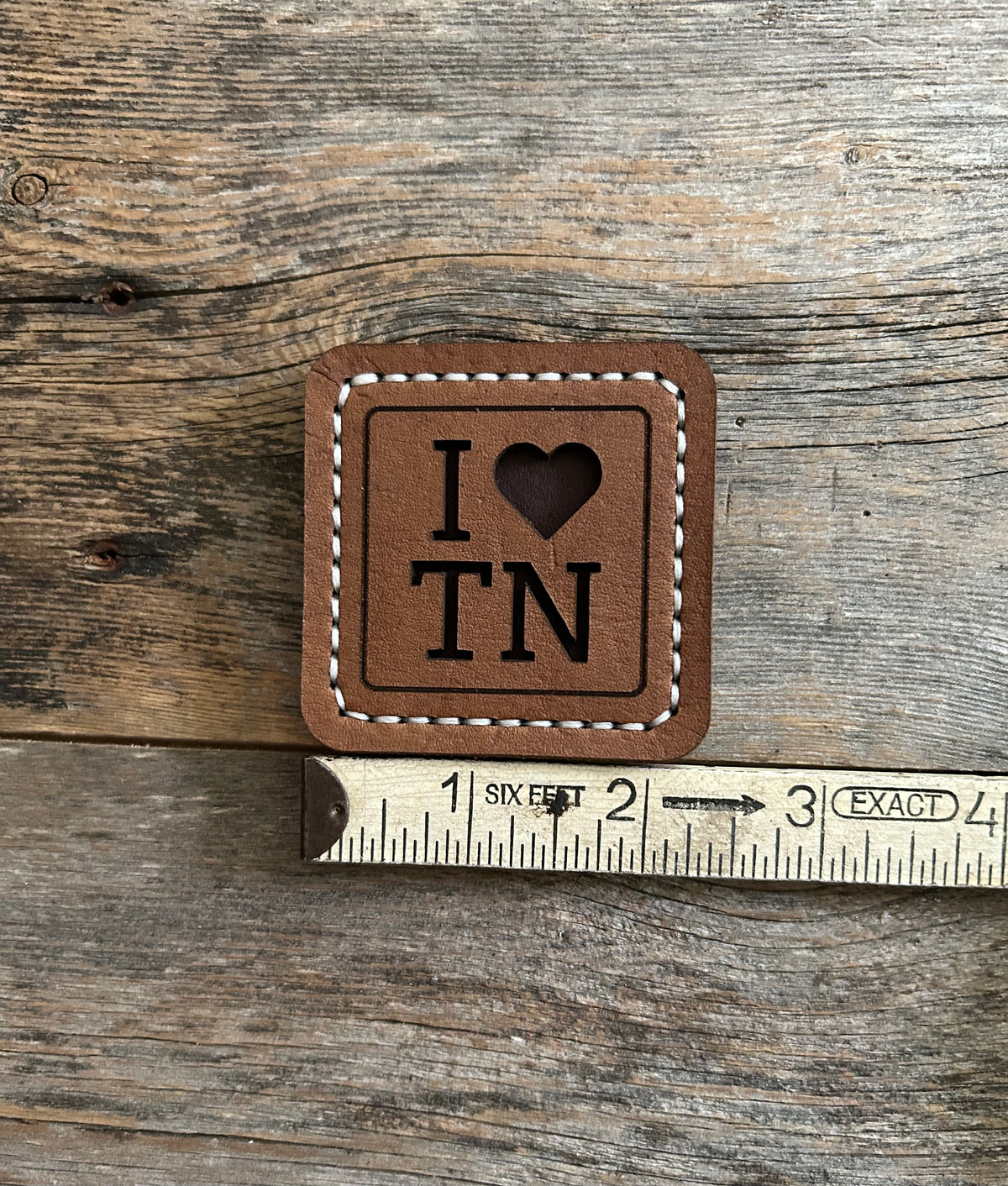 Hand-stitched brown leather magnet with an “I Love TN” design, handmade by Hutton Forge.