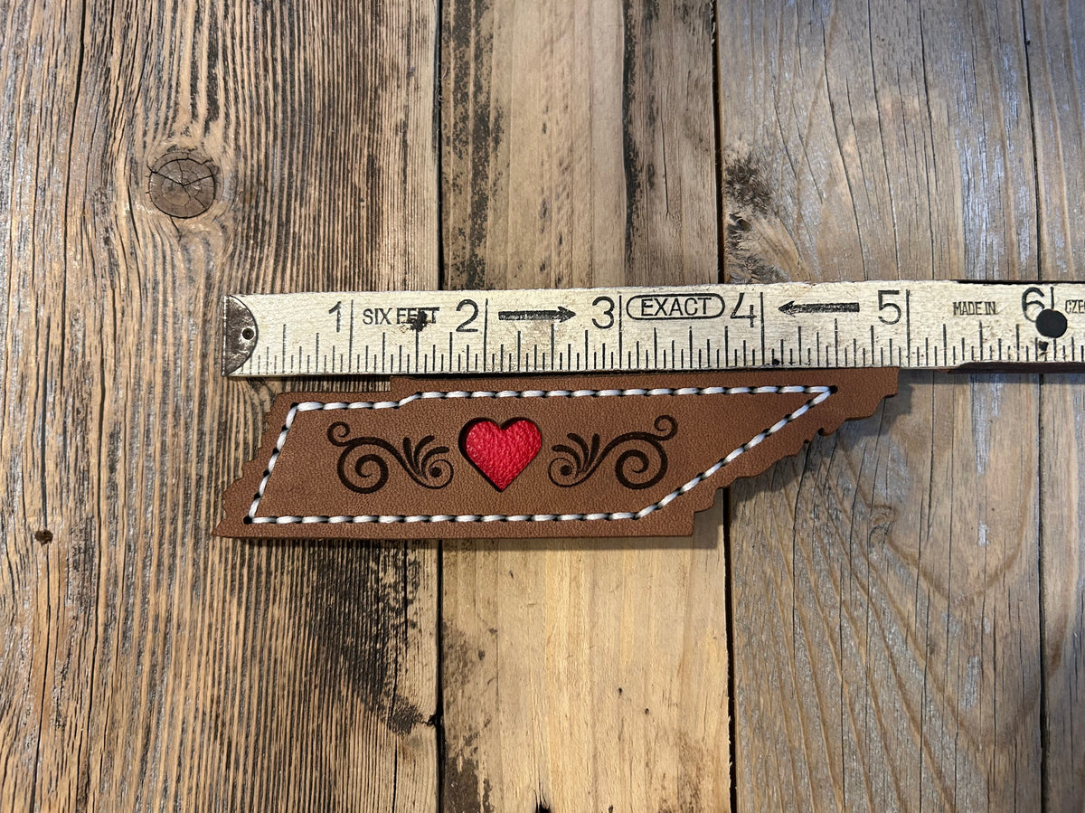 A Tennessee-shaped leather magnet with a red heart made by Hutton Forge. 