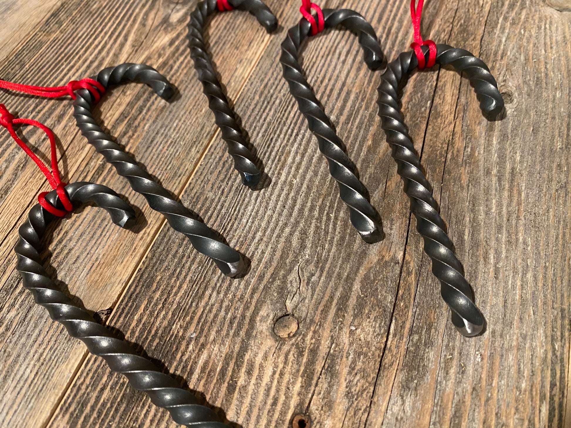Hand forged twisted steel candy cane ornaments. Made by Hutton Forge.