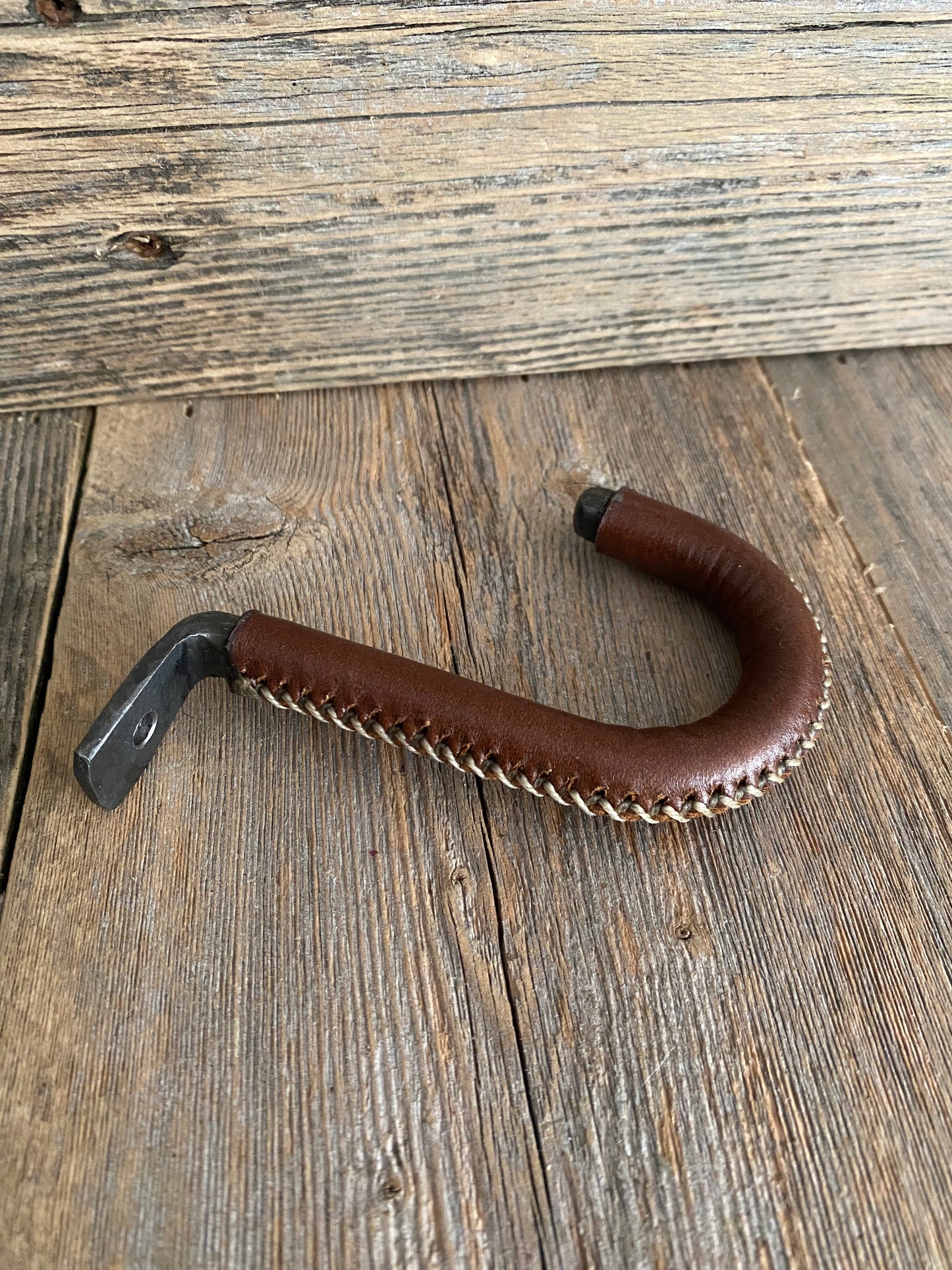 Our leather wrapped mug hooks are hand stitched. They are a really unique way to display your coffee mug collection under your kitchen cabinets. 