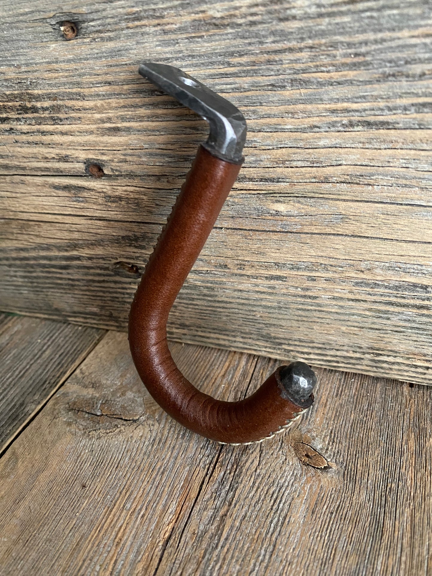 Our leather wrapped mug hooks are hand stitched. They are a really unique way to display your coffee mug collection under your kitchen cabinets. 
