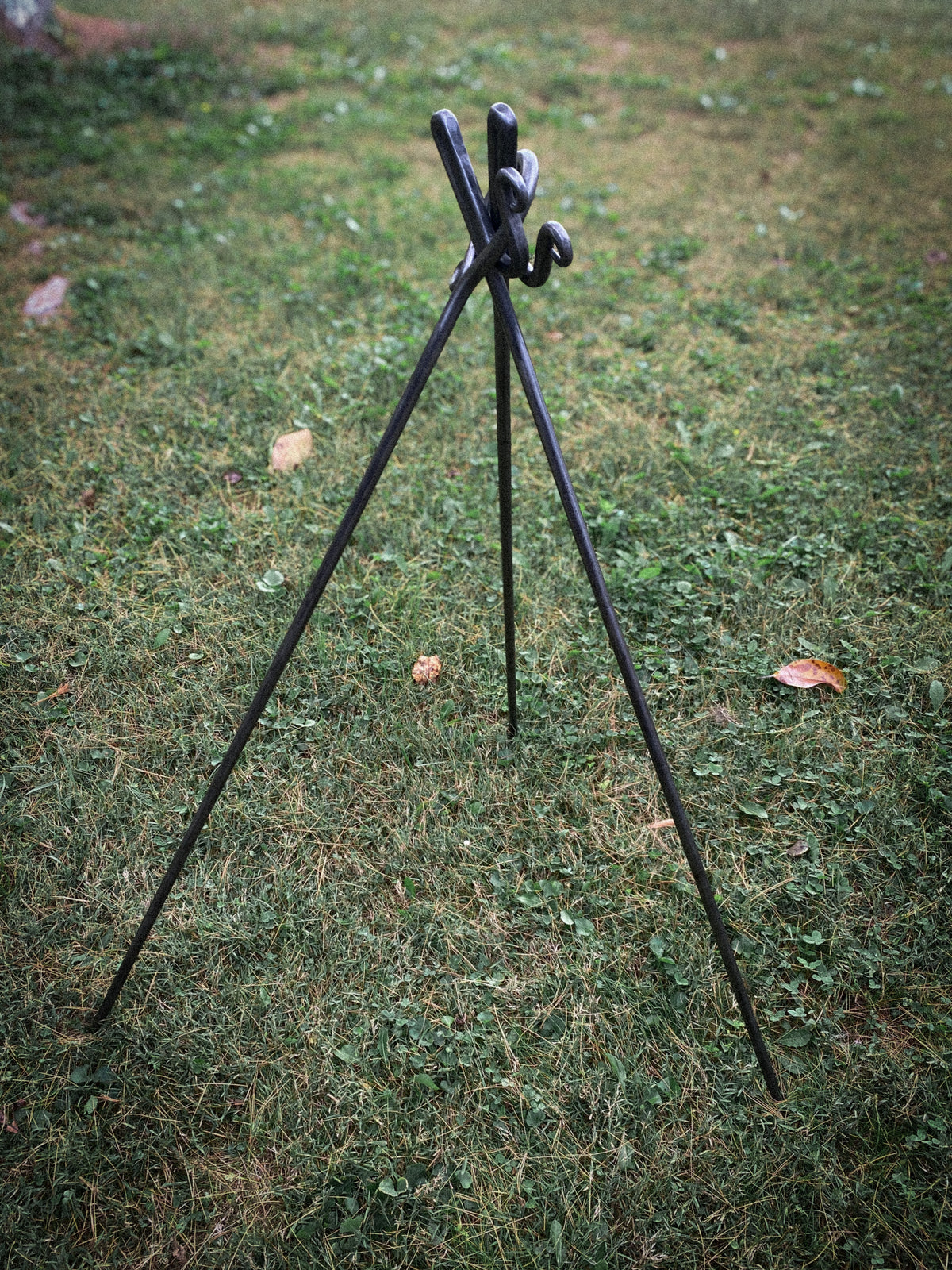 Hand-forged round steel campfire cooking tripod. Hutton Forge.