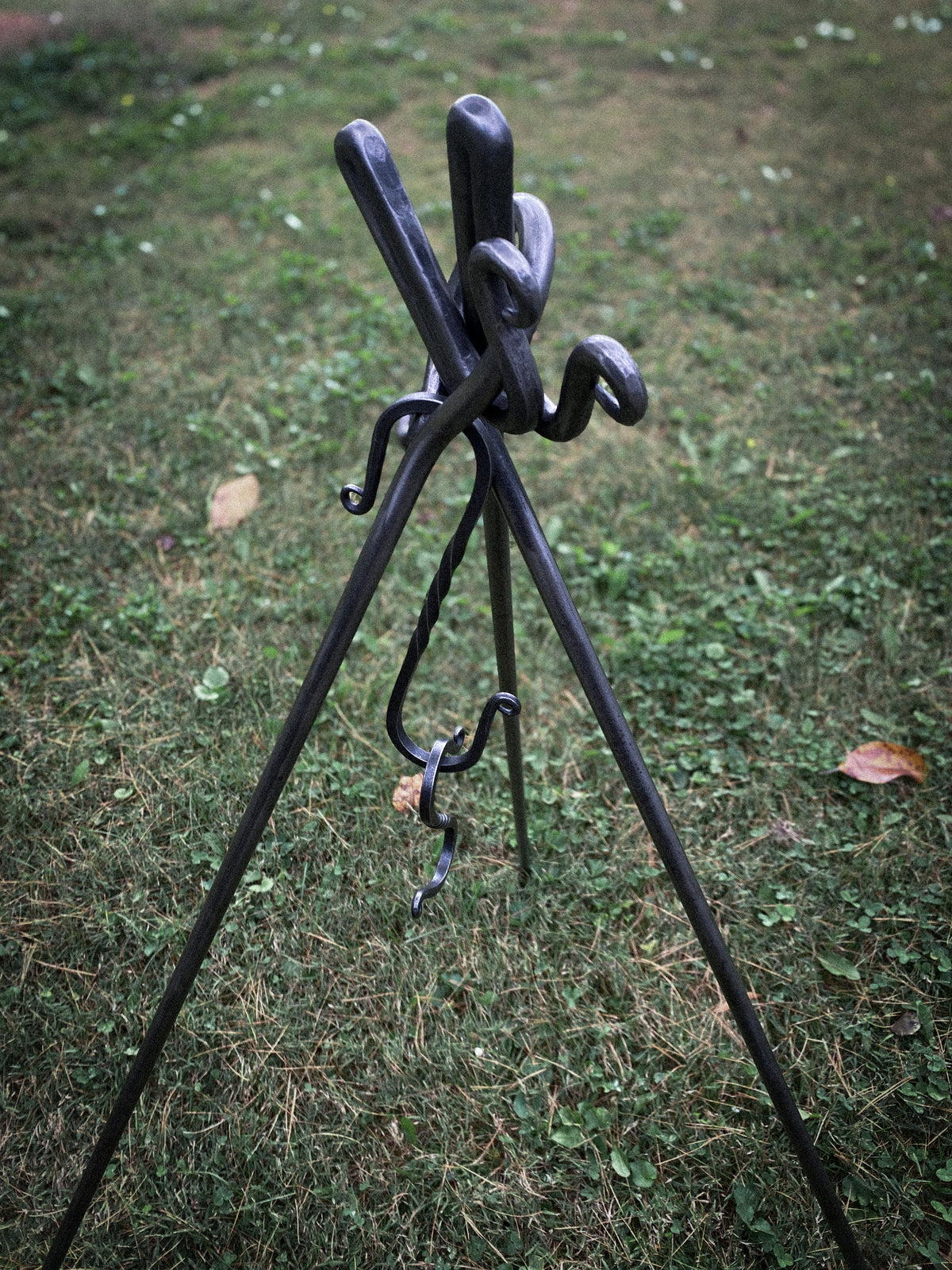 Hand-forged round steel campfire cooking tripod with 2 S hooks. Hutton Forge.