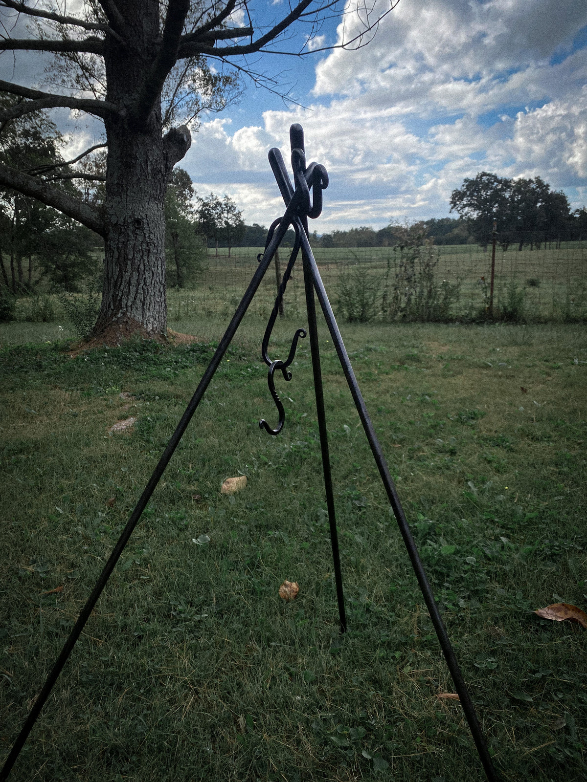 Hand-forged round steel campfire cooking tripod with 2 S hooks. Hutton Forge.