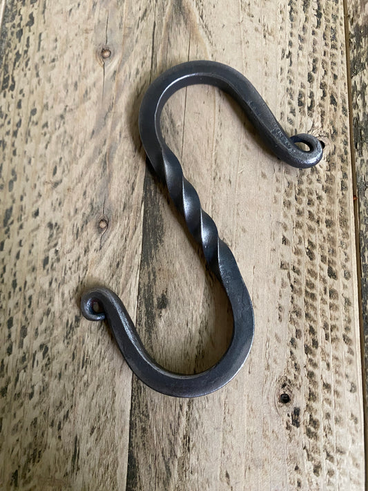 Forged twisted S-hook in blackened steel, featuring a decorative twisted center section and classic S-shape, handmade by Hutton Forge.

