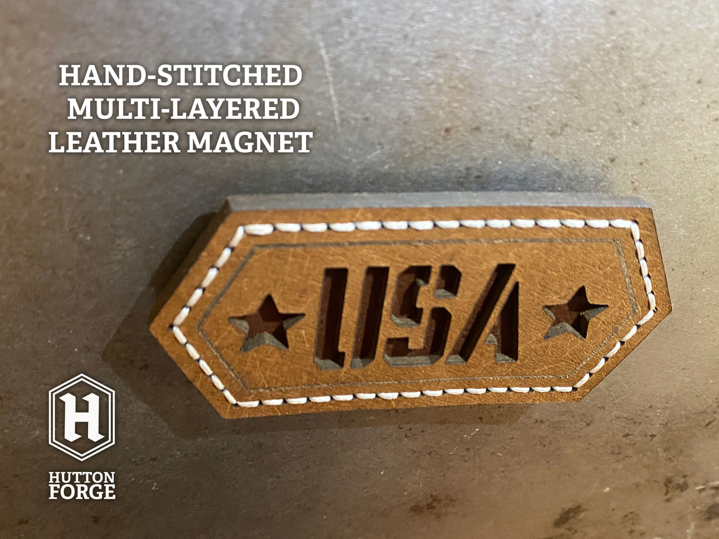 Hand-stitched brown leather magnet with cut-out “USA” lettering and stars, featuring white stitching on a hexagonal design. Hutton Forge.
