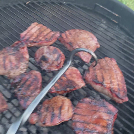 Video of Hand-forged steak flipper turning steaks over on the grill. Hutton Forge.
