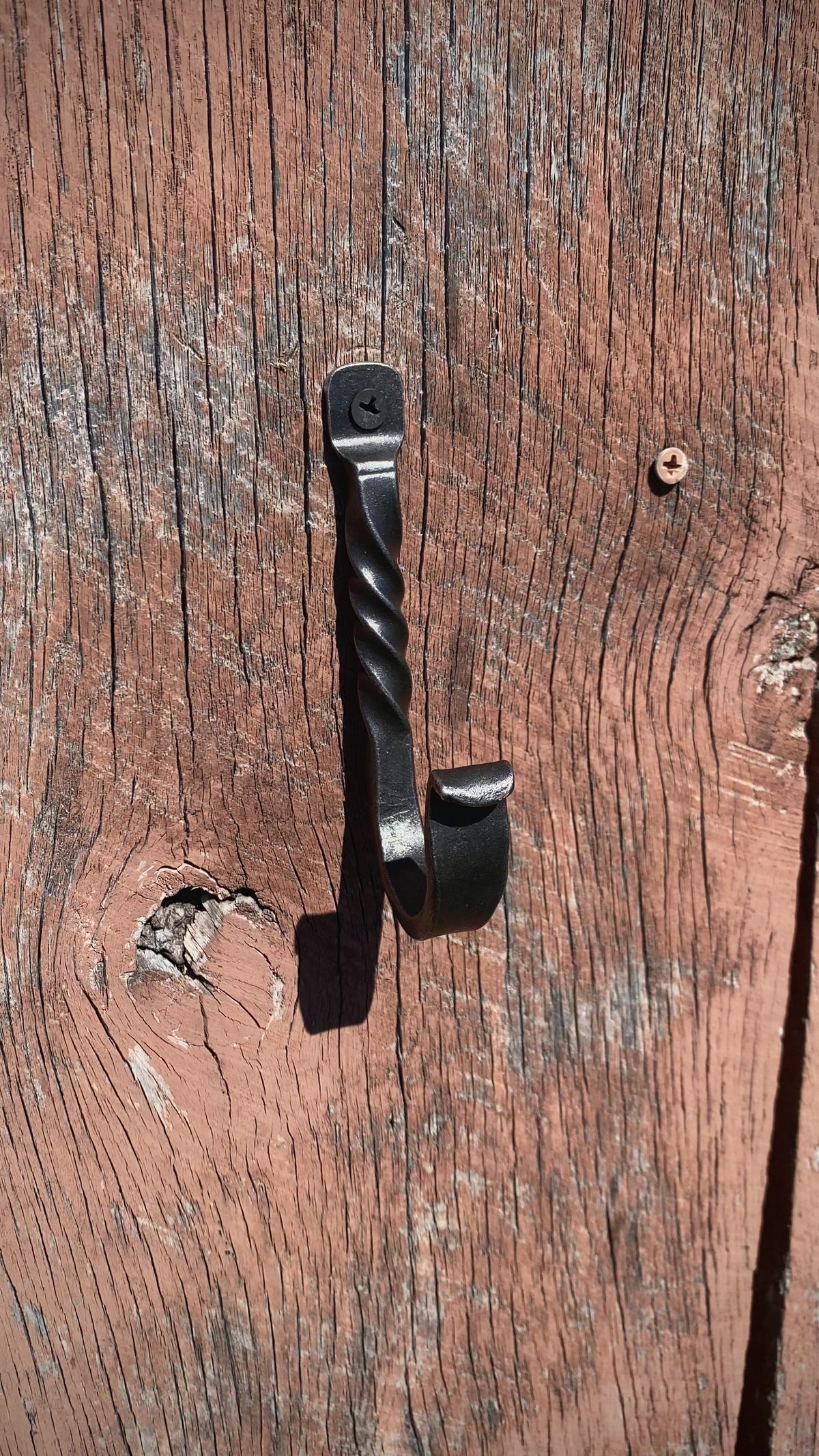 PersonHangingAHatOnASteelHook