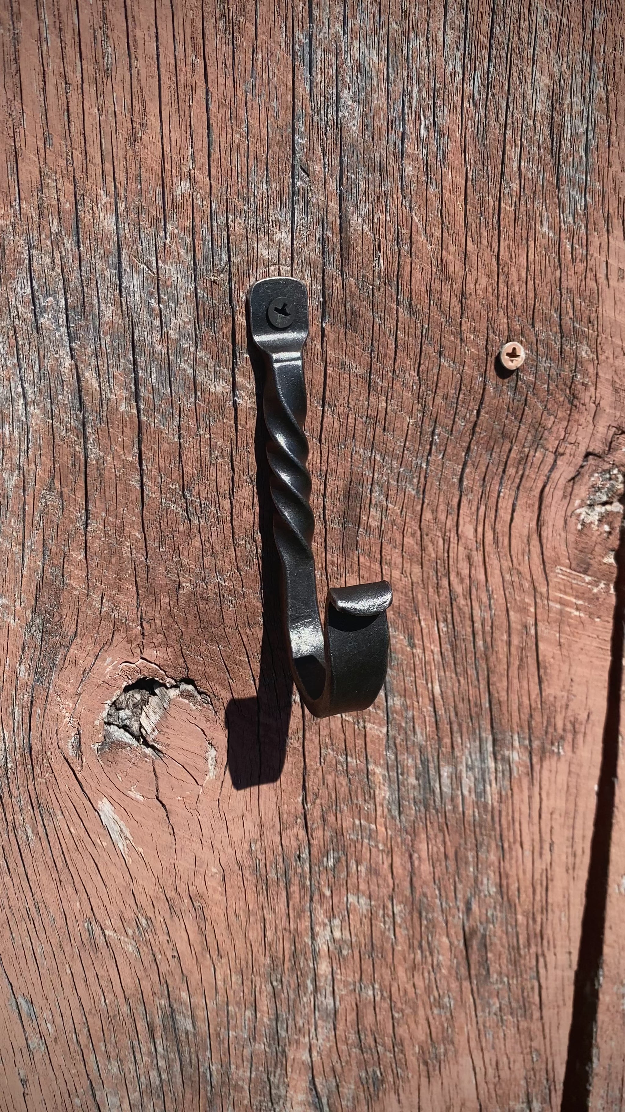 PersonHangingAHatOnASteelHook