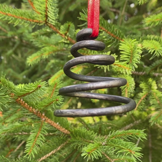 Unique blacksmith spiral Christmas tree ornaments hanging on a Christmas Tree. Hutton Forge
