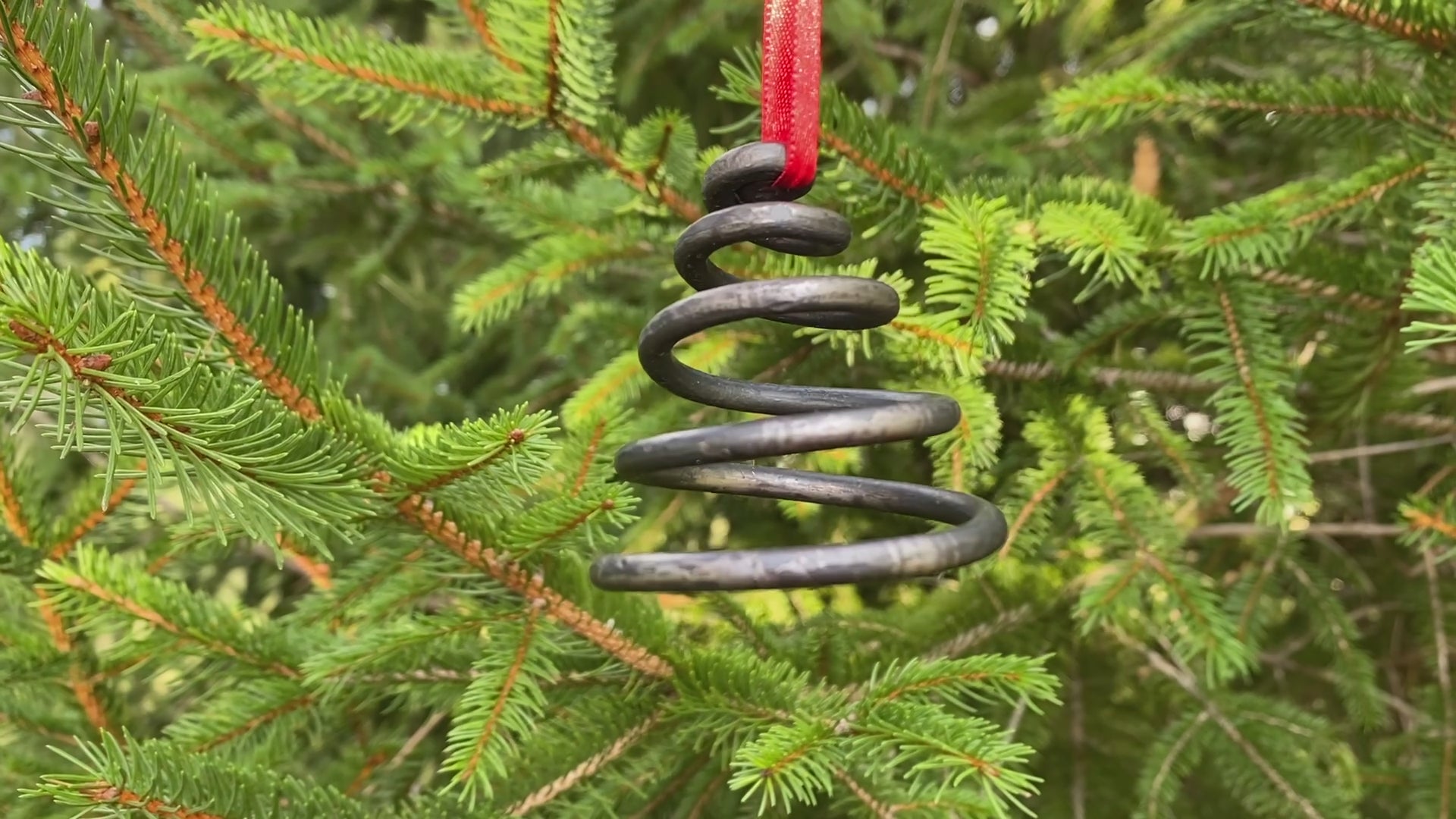 Unique blacksmith spiral Christmas tree ornaments hanging on a Christmas Tree. Hutton Forge